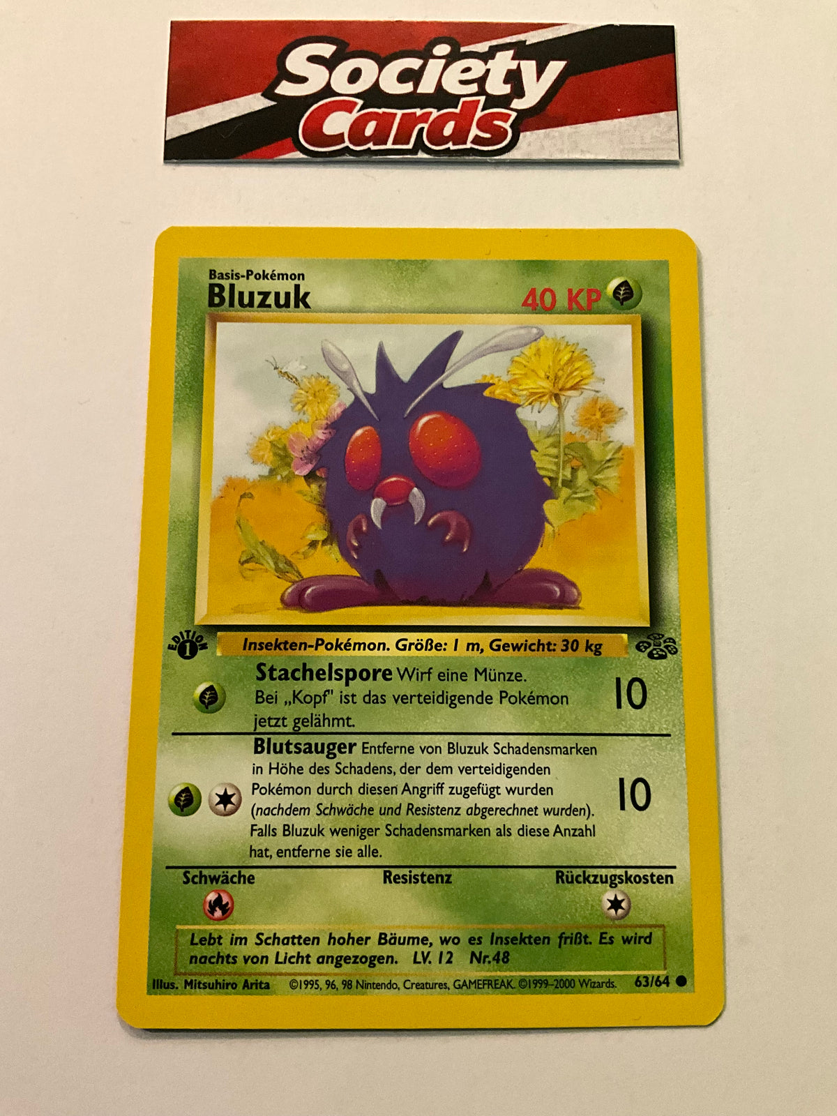 Pokémon Bluzuk 63/64 – Dschungel 1. Edition (Deutsch) – Excellent (EX)